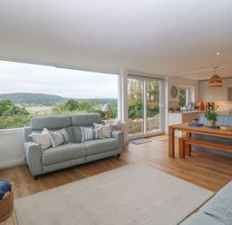 A living room with a sofa and table at Red Wharf Retreat Red Wharf Bay near Benllech