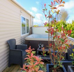 An outdoor area with a hot tub and seating at Plot 41 High Hesket near Armathwaite