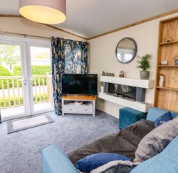 A living room with a television and a sofa at Plot 41 High Hesket near Armathwaite