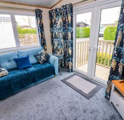 A living room with a sofa and television at Plot 41 High Hesket near Armathwaite