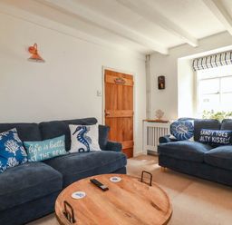 A living room with a sofa and coffee table at Stones Throw in Mevagissey