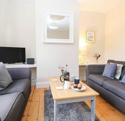 A living room with sofas and a coffee table at 19 Covert Road in Reydon