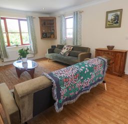 A living room with a sofa and coffee table at Yonde View in Camborne