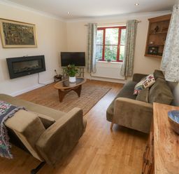 A living room with a television and a coffee table at Yonde View Camborne