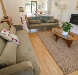 A living room with sofas and a coffee table at Yonde View in Camborne