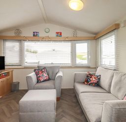 A living room with a sofa and television at Tucked Away in Newquay