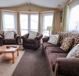 A living room with seating and a coffee table at Winchester - 478 Abergele