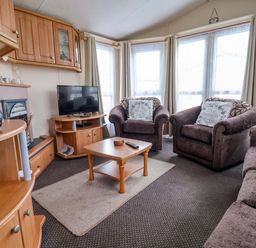 A living room with a television and sofas at Winchester - 478 Abergele