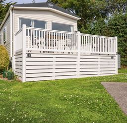 An outdoor view of a caravan with a deck at 5 Silverbow