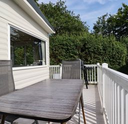A deck with a table and chairs at 5 Silverbow