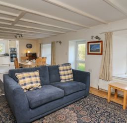 A living room with a sofa and table at Tegfan in Newport