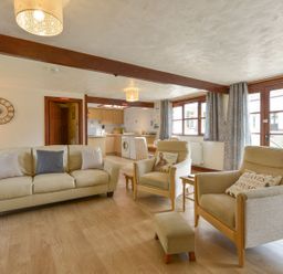 A living room with a sofa and armchairs at Pillhead Cart Linhay in Bideford