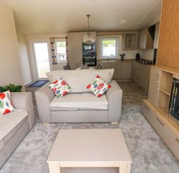 A living room with a sofa and coffee table at Sandpiper in Narberth