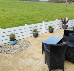 An outdoor patio area with chairs and a table at O7 in Abersoch