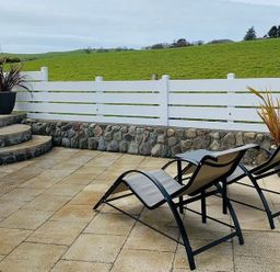 An outdoor area with lounge chairs and plants at O7 in Abersoch