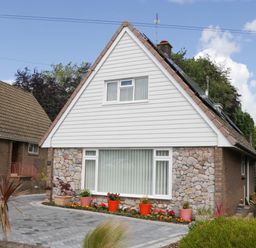 A house with a stone exterior and garden at Halsdon Avenue Exmouth