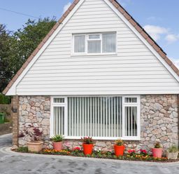 A house with a stone wall and front garden at Halsdon Avenue Exmouth