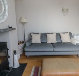 A living room with a sofa and coffee table at Arosfa in New Quay