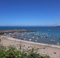 A beach with boats in the water at Arosfa New Quay