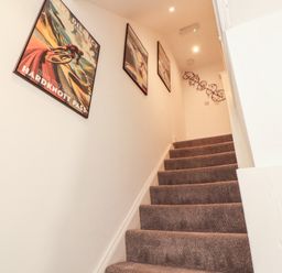 A staircase with posters on the wall at Hidden Gem in 