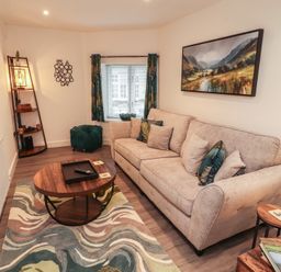 A living room with a sofa and coffee table at Hidden Gem in 