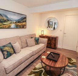 A living room with a sofa and coffee table at Hidden Gem in 