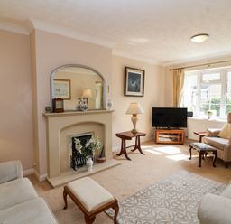 A living room with a fireplace and television at Number 10, Broadway