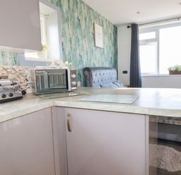 A kitchen featuring a toaster and microwave at Two Bed Apartment No.4 Newquay