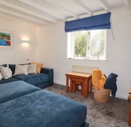 A living room with a sofa and coffee table at Little House in Wadebridge