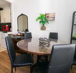 A dining room with a table and chairs at Ocean Breeze in Weymouth