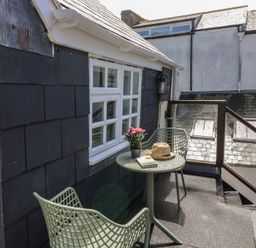 A balcony with a table and chairs at 15D Foss Street Dartmouth