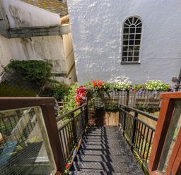 A staircase leading down with plants and flowers at 15D Foss Street Dartmouth