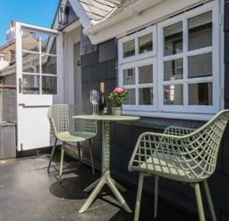 An outdoor seating area with a table and chairs at 15D Foss Street in Dartmouth