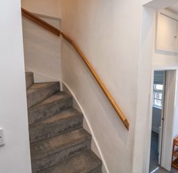 A staircase leading up with a handrail in a hallway at 15D Foss Street Dartmouth