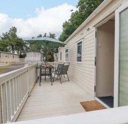 An outdoor area with a table and chairs at Foxglove 4 in Ringwood