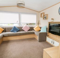 A living room with a sofa and television at Foxglove 4 in Ringwood