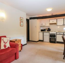 A living room with a kitchen area at Flat 4 Grasmere Lodge in Ambleside