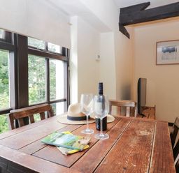 A dining room with a table and chairs at Flat 4 Grasmere Lodge in Ambleside