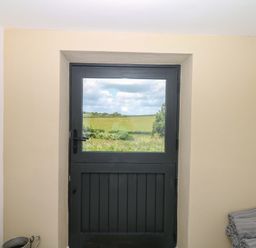 A door and window with a view of fields at Reddaway Byre Okehampton
