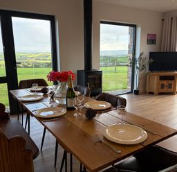 A dining room with a table set for dinner at High View Barn in Launceston