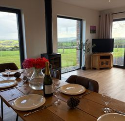 A dining room with a table set for a meal at High View Barn in Launceston