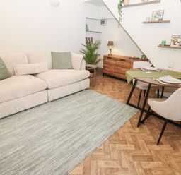 A living room with a sofa and dining area at Corner House in Wark