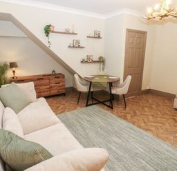 A living room with a sofa and dining area at Corner House in Wark