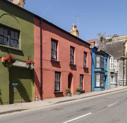 A street with colorful houses and flower boxes at 11b Market Street in Narberth