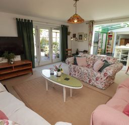 A living room with a television and sofa at 11b Market Street in Narberth
