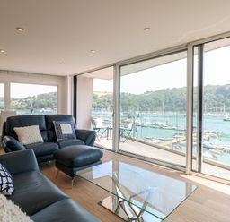 A living room with a view of the water at 5 Sails in Dartmouth