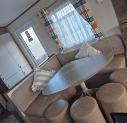 A dining area with a table and seating at Unity Beach in Burnham-on-Sea