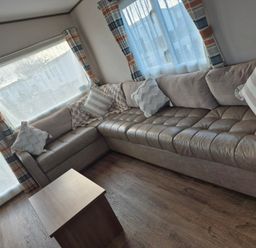 A living room with a sofa and coffee table at Unity Beach - Abi Ryedale in Burnham-on-Sea