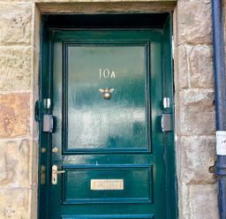A green door with number 10A and a knocker at Downton I Alnwick