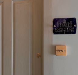 A door with a nameplate at Downton Apartments I in Alnwick